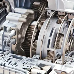 Przekładnia automatyczna w przekroju, pokazująca mechanizm, jak działa automatyczna skrzynia biegów, z widocznymi kołami zębatymi i elementami hydraulicznymi.