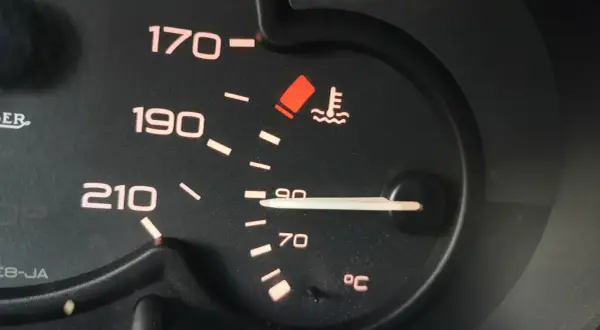 Czerwona kontrolka temperatury oleju świeci się, wskazując na przegrzewanie silnika. Wskaźnik pokazuje ponad 90°C.