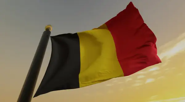 Flaga Belgii powiewa na wietrze. Uważaj na auta z belgii dokumenty, bo mogą być problematyczne.