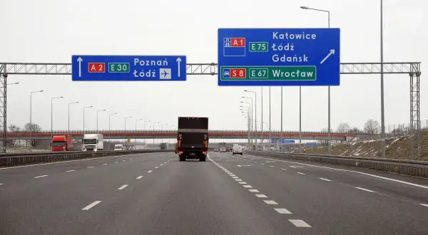Droga ekspresowa S8 i autostrada A1, A2. Znaki drogowe pokazują kierunki do Poznania, Łodzi, Katowic, Gdańska i Wrocławia.