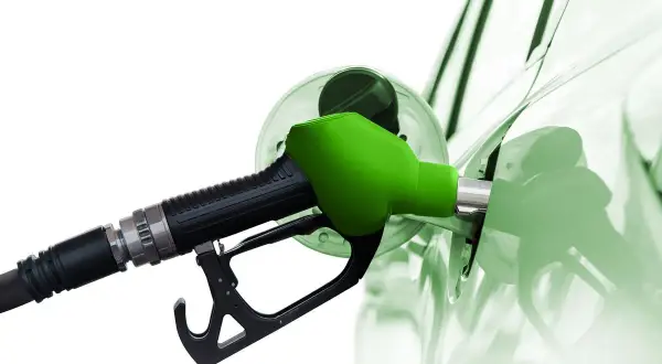 Zielona dysza dystrybutora tankuje samochód. To paliwo diesel, które zasila silniki.