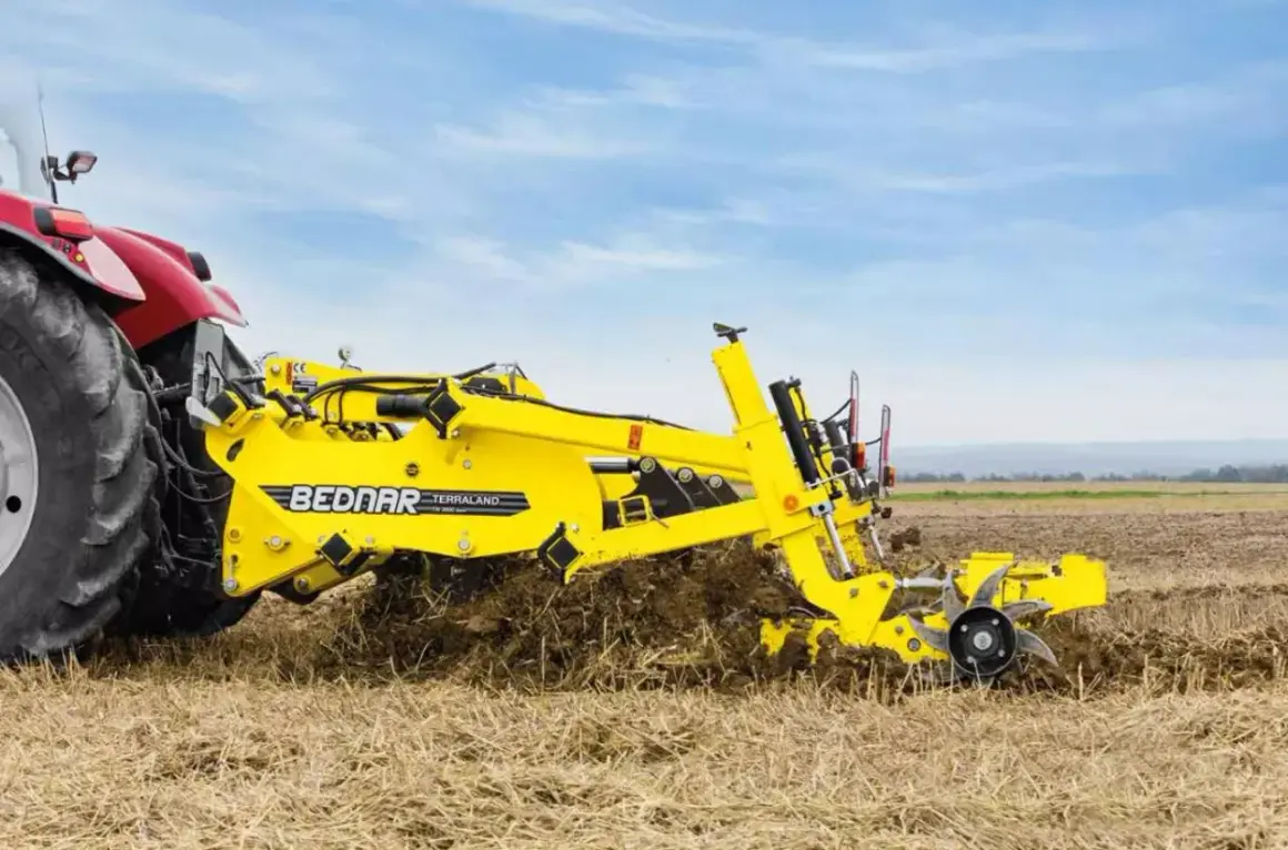 Czerwony traktor z żółtym agregatem uprawowym Bednar Terraland pracuje na polu.