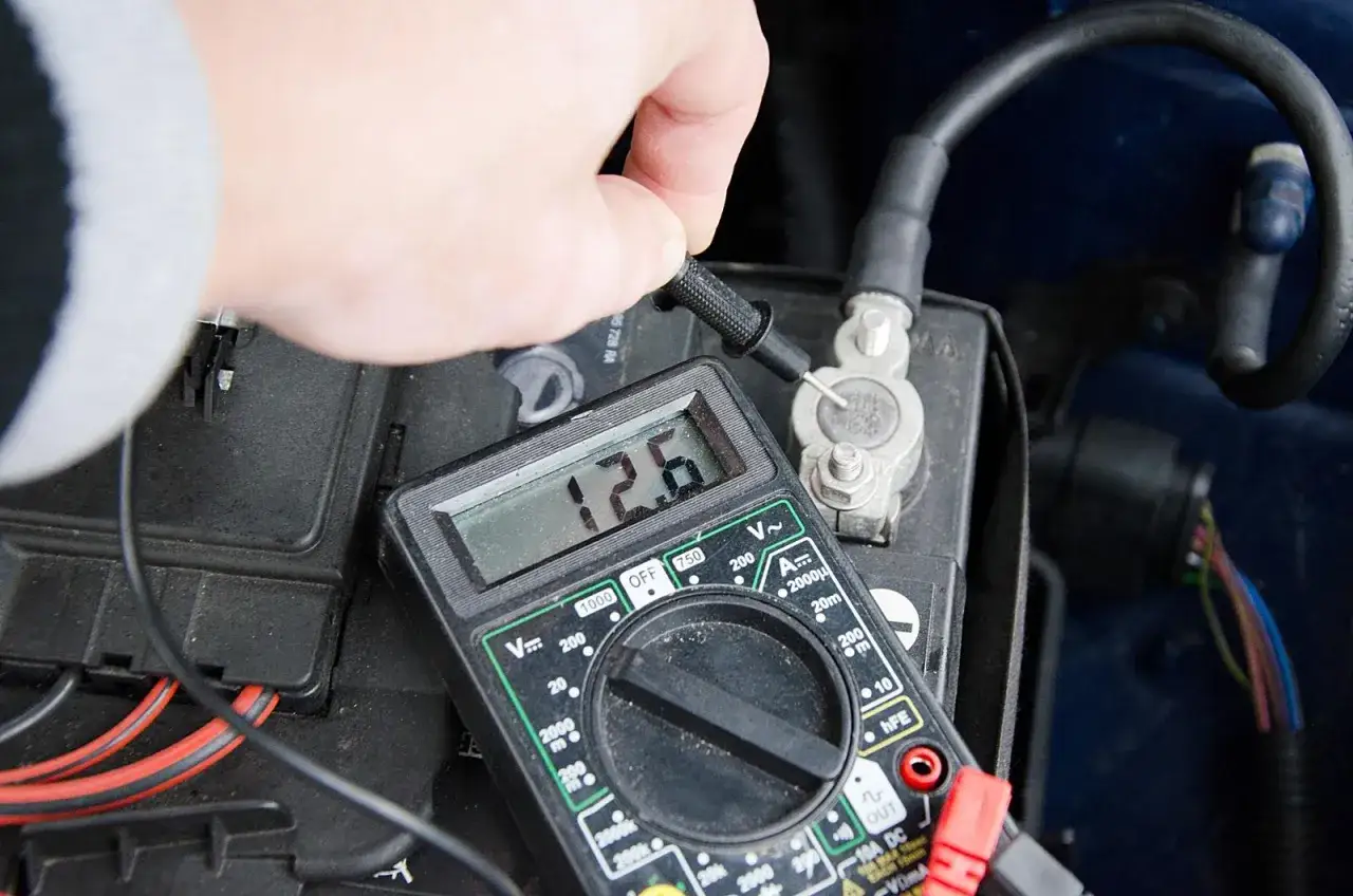 Pomiar napięcia multimetrem pokazuje 12.6V, co jest dobrym sposobem, jak sprawdzić stan akumulatora.