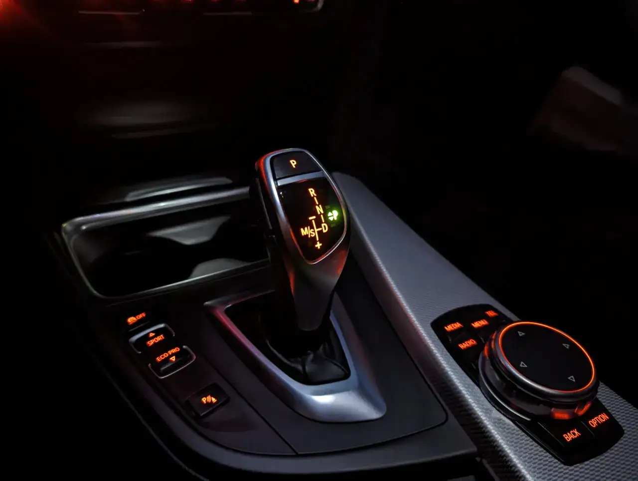 Bieg ZF 8HP w BMW. Widok na dźwignię zmiany biegów, przyciski trybów jazdy (Sport, Eco Pro) i pokrętło iDrive.
